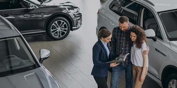 Sale person discussing with electric car